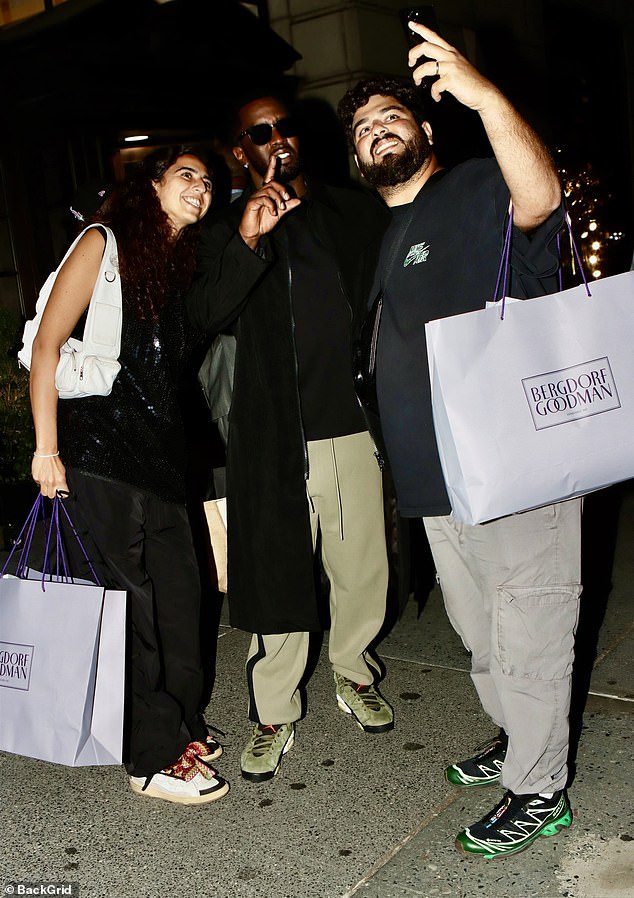 Combs made a hand gesture as he stood alongside fans in NYC Monday