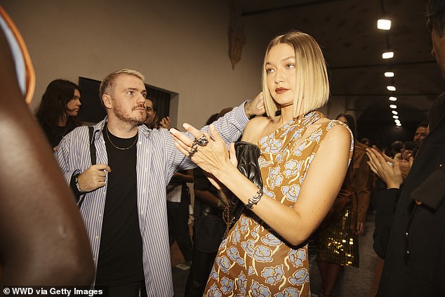 A hair stylish did some finishing touches before she headed on stage