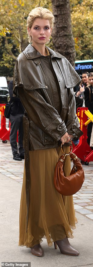 Outside the venue Pixie covered up in a dark chocolate brown leather jacket