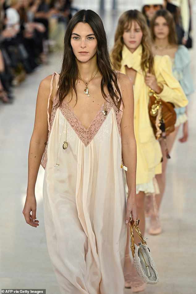 Vittoria Ceretti took to the runway as she fashioned a floaty pink slip dress with lace detailing