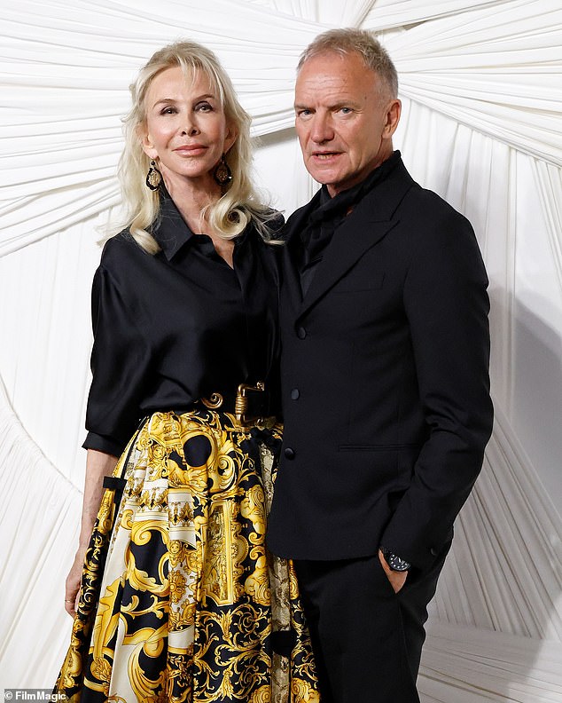 She posed with her husband and music artist, Sting, who opted for a black suit as well as a black shirt underneath