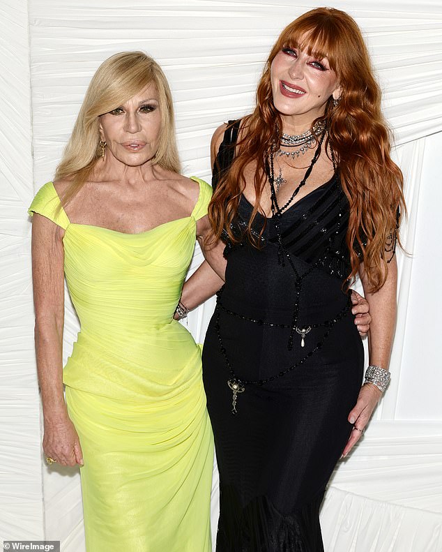 Tilbury held a smile as she crossed paths with Donatella Versace during a photo session
