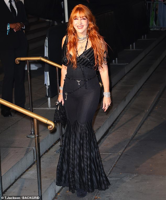 She slipped into a pair closed-toed, black heels and allowed her reddish locks to cascade down past her shoulders in elegant waves