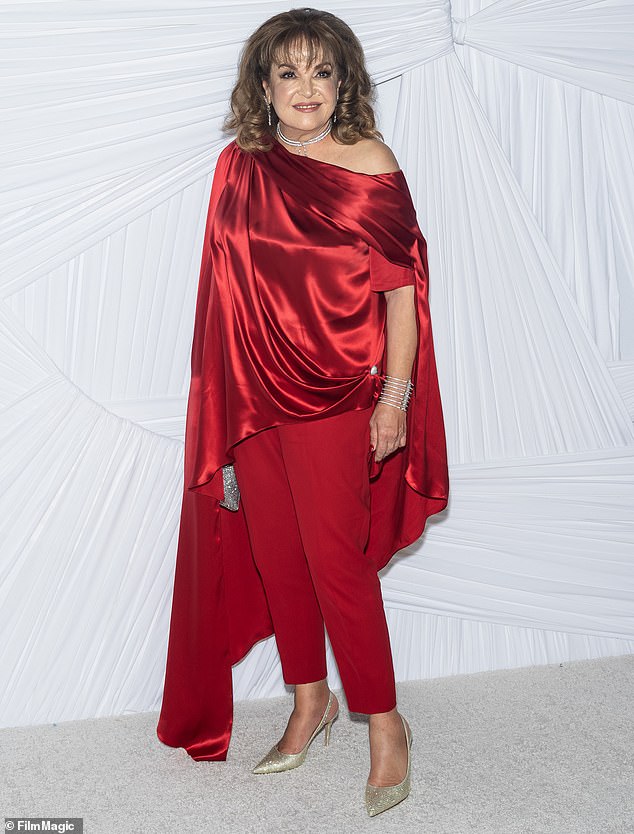 Baria Alamuddin was radiant in a pair of red trousers as well as a red, satin caped shirt that flowed down towards the ground on the right side