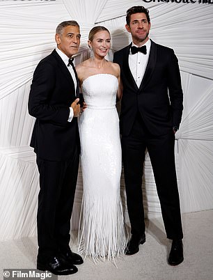 Emily and John held smiles on their faces as they were joined by George Clooney during a brief photo session