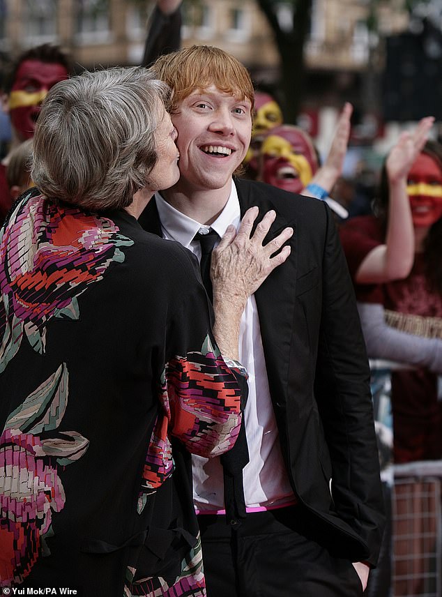 Dame Maggie Smith kisses Rupert Grint as they arrive for the world premiere of Harry Potter and the Half-Blood Prince at the Odeon Leicester Square in London on July 7, 2009