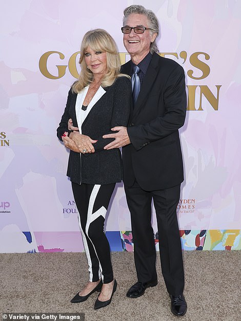 The Tombstone actor was dressed for the occasion in a classic, black suit as well as a black shirt and blue tie which added a pop of color to the outfit