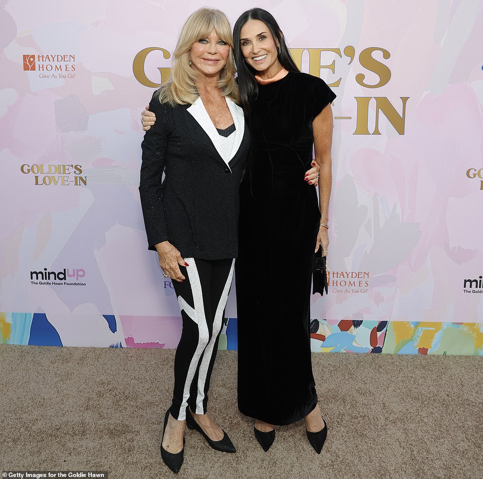Hawn was also seen crossing paths with Demi Moore and the pair held big smiles on their faces as they stopped for a photo