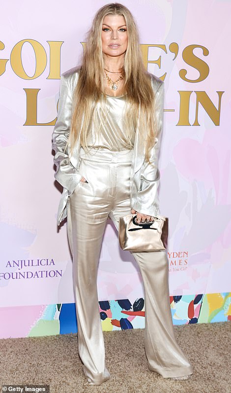 Fergie was radiant wearing champagne-colored, satin trousers as well as a matching shirt and blazer that was left unfastened at the front