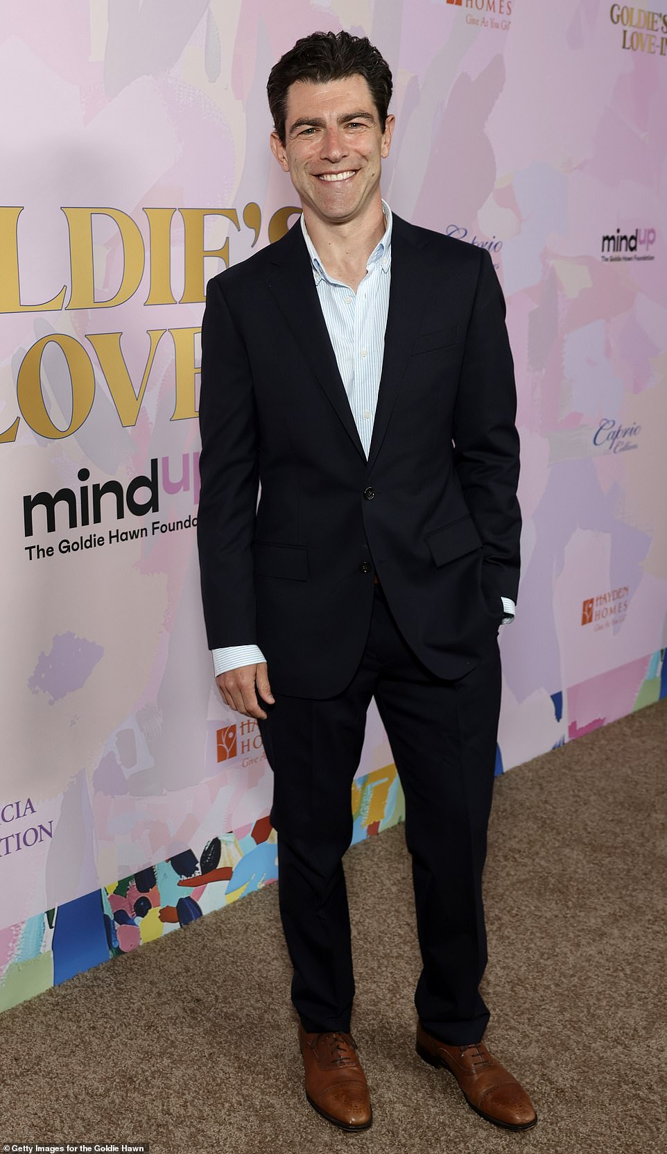 Max Greenfield dressed for the occasion in a pair of black slacks as well as a matching suit jacket and light blue shirt