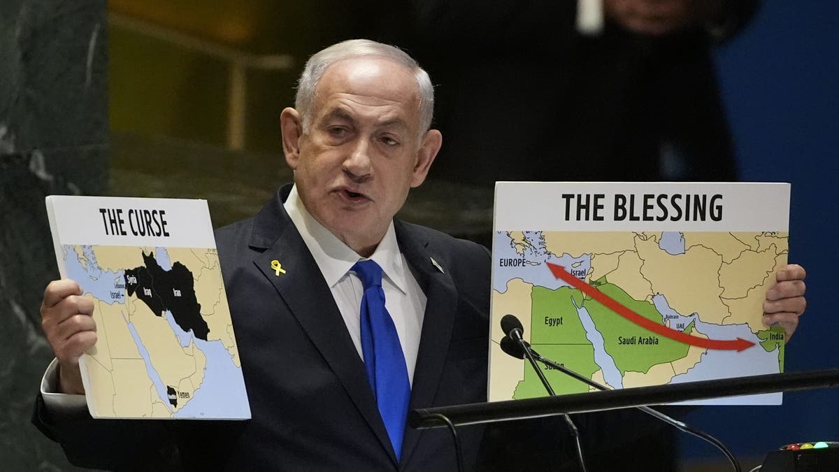 Premijer Izraela Benjamin Netanyahu drži natpise dok se obraća na 79. sjednici Opće skupštine Ujedinjenih naroda u petak, 27. rujna 2024.