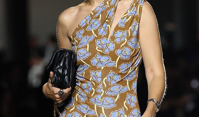 Gigi Hadid storms the Versace runway in an asymmetrical floral dress as she joins Vittoria Ceretti and Iris Law on the catwalk at Milan Fashion Week