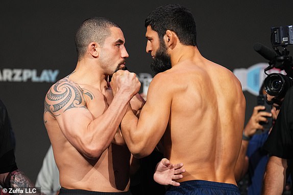 ABU DHABI, UNITED ARAB EMIRATES - OCTOBER 25: (L-R) Opponents Robert Whittaker of New Zealand and Khamzat Chimaev of Russia face off during the UFC 308 ceremonial weigh-in at Etihad Arena on October 25, 2024 in Abu Dhabi, United Arab Emirates. (Photo by Chris Unger/Zuffa LLC)