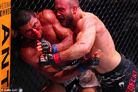 ABU DHABI, UNITED ARAB EMIRATES - OCTOBER 26: (R-L) Mateusz Rebecki of Poland punches Myktybek Orolbai of Kyrgyzstan in a 160-pound catchweight fight during the UFC 308 event at Etihad Arena on October 26, 2024 in Abu Dhabi, United Arab Emirates.  (Photo by Chris Unger/Zuffa LLC)