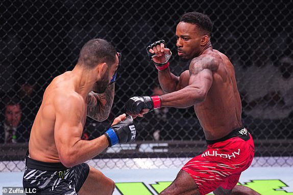 ABU DHABI, UNITED ARAB EMIRATES - OCTOBER 26: (R-L) Lerone Murphy of England punches Dan Ige in a featherweight fight during the UFC 308 event at Etihad Arena on October 26, 2024 in Abu Dhabi, United Arab Emirates.  (Photo by Chris Unger/Zuffa LLC)