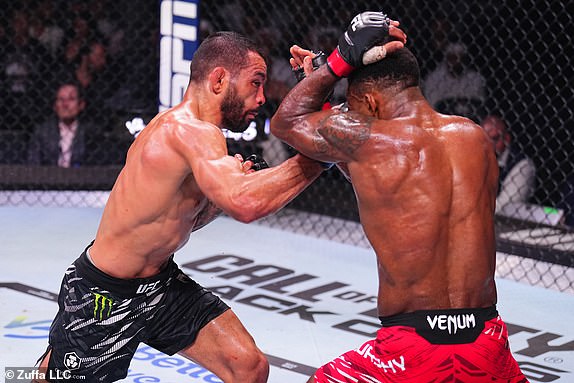 ABU DHABI, UNITED ARAB EMIRATES - OCTOBER 26: (L-R) Dan Ige punches Lerone Murphy of England in a featherweight fight during the UFC 308 event at Etihad Arena on October 26, 2024 in Abu Dhabi, United Arab Emirates.  (Photo by Chris Unger/Zuffa LLC)