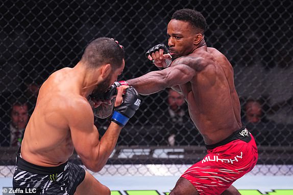 ABU DHABI, UNITED ARAB EMIRATES - OCTOBER 26: (R-L) Lerone Murphy of England punches Dan Ige in a featherweight fight during the UFC 308 event at Etihad Arena on October 26, 2024 in Abu Dhabi, United Arab Emirates.  (Photo by Chris Unger/Zuffa LLC)