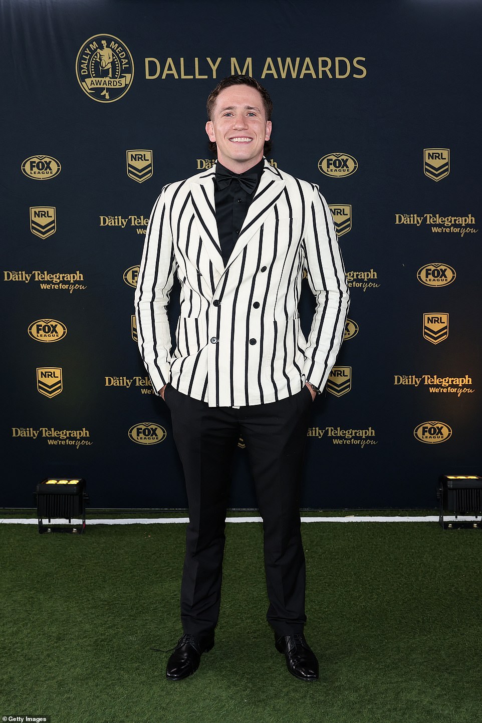 Cooper Johns (pictured) paid tribute to his former coach Craig Bellamy by wearing a black and white striped double-breasted blazer
