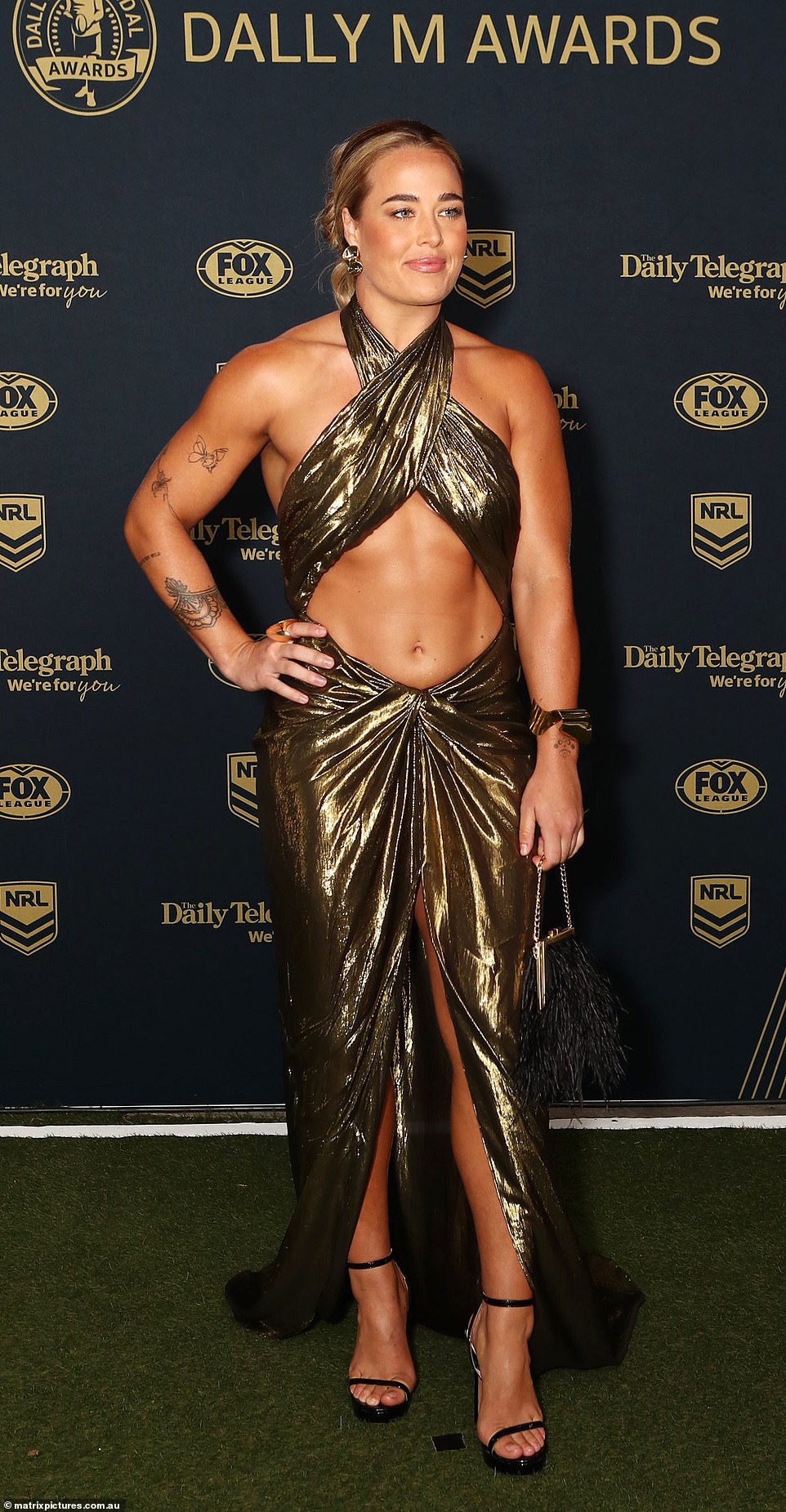 The 2024 Dally M Awards is officially underway, with several female footy stars slipping into daring flesh-baring gowns on the red carpet. Pictured: Isabelle Kelly