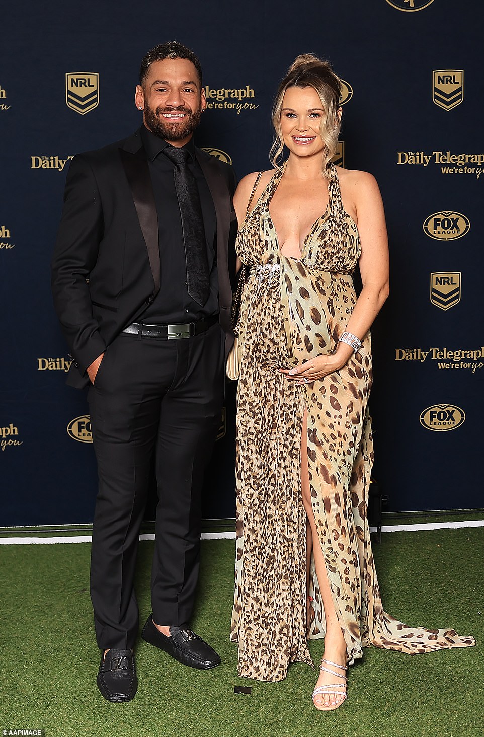 Tigers star Apisai Koroisau smiled alongside his pregnant wife Amy Koroisau, who showed off her growing baby bump in a leopard print dress