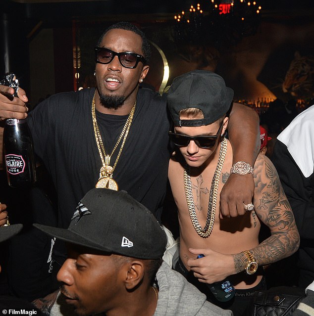 But of course, that seemingly innocent interaction has now taken on a sinister new meaning, for the man who was sat with Bieber was Sean ' Diddy ' Combs. They are pictured here in 2014.