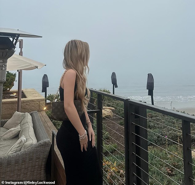 Finley dressed for the occasion in a fitted, sleeveless black dress and easily carried a small, Louis Vuitton purse over her right shoulder
