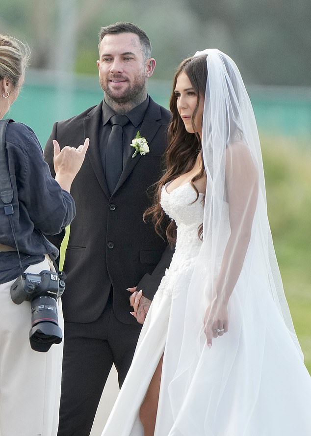 For makeup, she chose a rosy bridal look with a pink lipstick and added simple pearl earrings