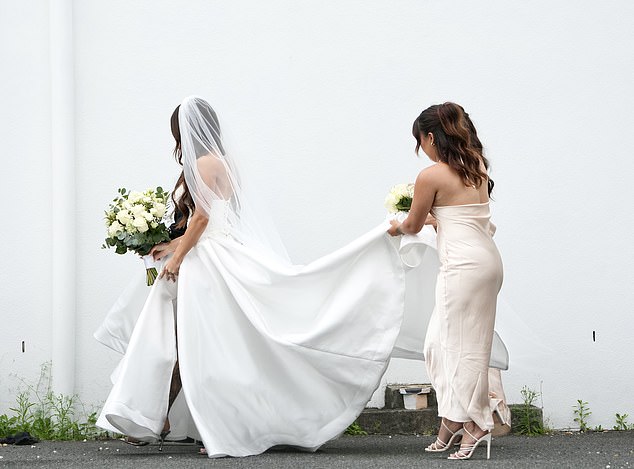 The bride carried a large bouquet of white flowers