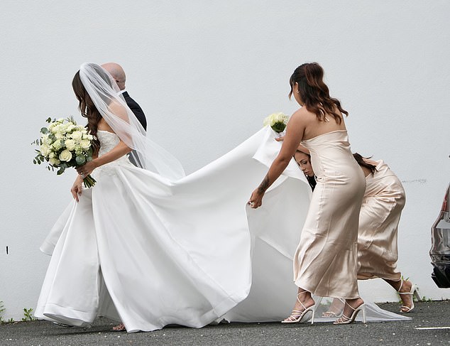 The bride was helped along by a posse of bridesmaids in coffee toned satin dresses