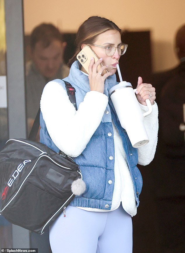 She sipped water from her Stanley cup and chatted on the phone