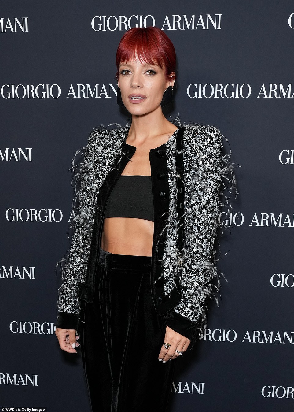 Lily Allen showed off her abs in a black crop top and high-waisted velvet slacks