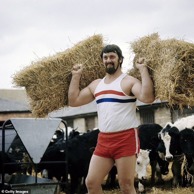 Portrait of Shot Put champion, Worlds Strongest man and budgerigar breeder Geoff Capes from Great Britain training with straw bales on 1st September 1978 in Spalding, United Kingdom