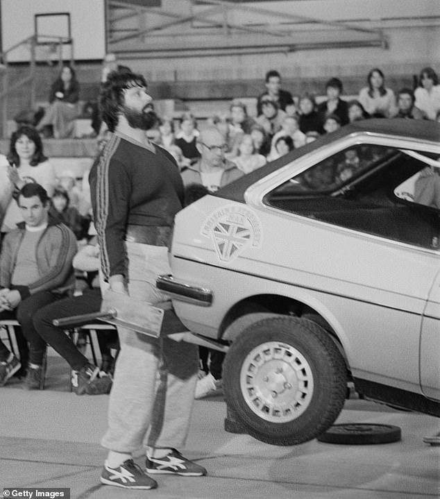 Professional Highland Games competitor Geoff Capes lifting a car, UK, 19th April 1979