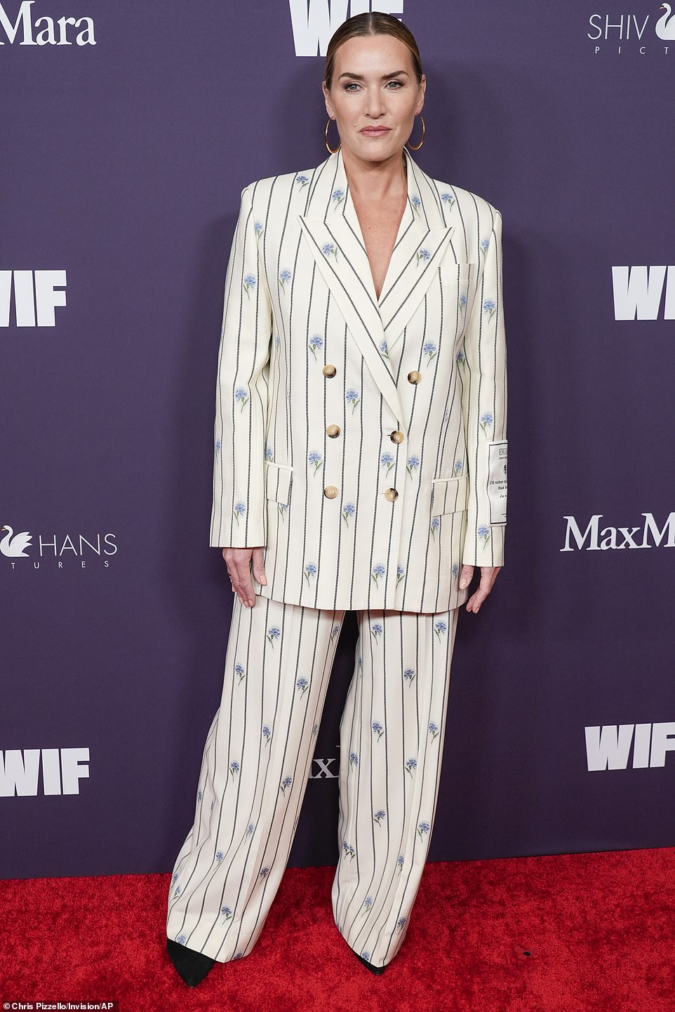 Kate Winslet looked ultra chic in a white pinstripe suit boasting an elegant blue floral pattern