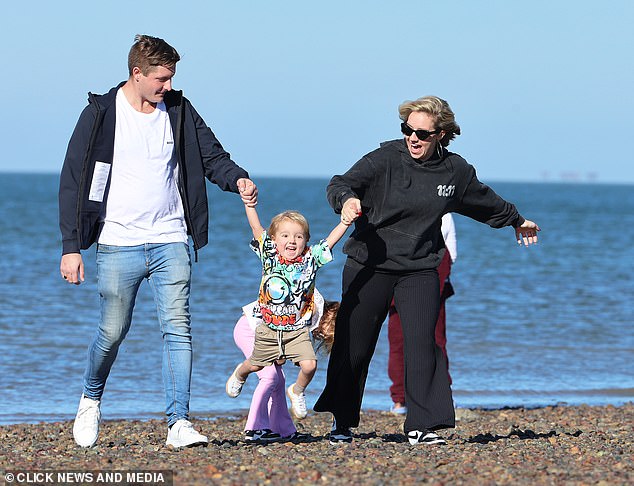 The mother of two, 34, and her new partner, 27, who is a tree surgeon from Kent, enjoyed a romantic stroll across the beach with her children Amelia, five, and Bodhi, three