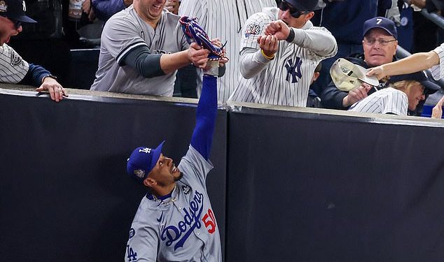 Mookie Betts i Dodgers reagiraju na navijača Yankeesa koji mu pokušava otrgnuti loptu iz ruke u utakmici Svjetskog prvenstva