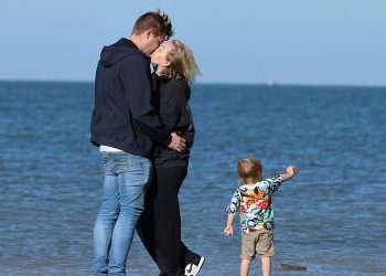 Tom Parker’s widow Kelsey shares a romantic kiss on the beach with boyfriend Will Lindsay during a family holiday – two years after The Wanted star’s death