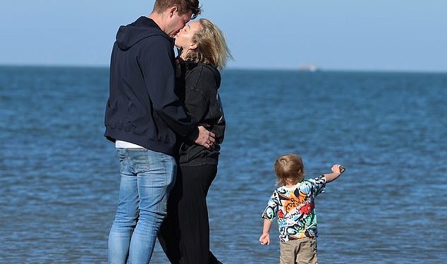 Tom Parker’s widow Kelsey shares a romantic kiss on the beach with boyfriend Will Lindsay during a family holiday – two years after The Wanted star’s death