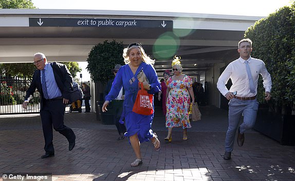 MELBOURNE, AUSTRALIA - NOVEMBER 05: Race goers arrive during Melbourne Cup Day at Flemington Racecourse on November 05, 2024 in Melbourne, Australia. (Photo by Daniel Pockett/Getty Images)