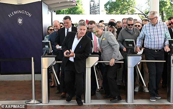 Racegoers queue at the gates prior to the 2024 Melbourne Cup at Flemington Racecourse in Melbourne, Tuesday, November 5, 2024. (AAP Image/James Ross) NO ARCHIVING, EDITORIAL USE ONLY