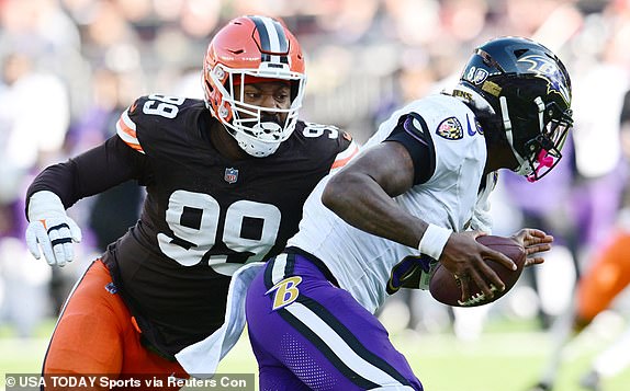 Oct 27, 2024; Cleveland, Ohio, USA; Cleveland Browns defensive end Za'Darius Smith (99) sacks Baltimore Ravens quarterback Lamar Jackson (8) during the second half at Huntington Bank Field. Mandatory Credit: Ken Blaze-Imagn Images