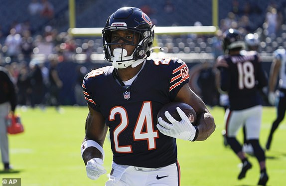 Chicago Bears running back Khalil Herbert runs the ball during warmups before an NFL football game against the Carolina Panthers Sunday, Oct. 6, 2024, in Chicago. (AP Photo/Nam Y. Huh)