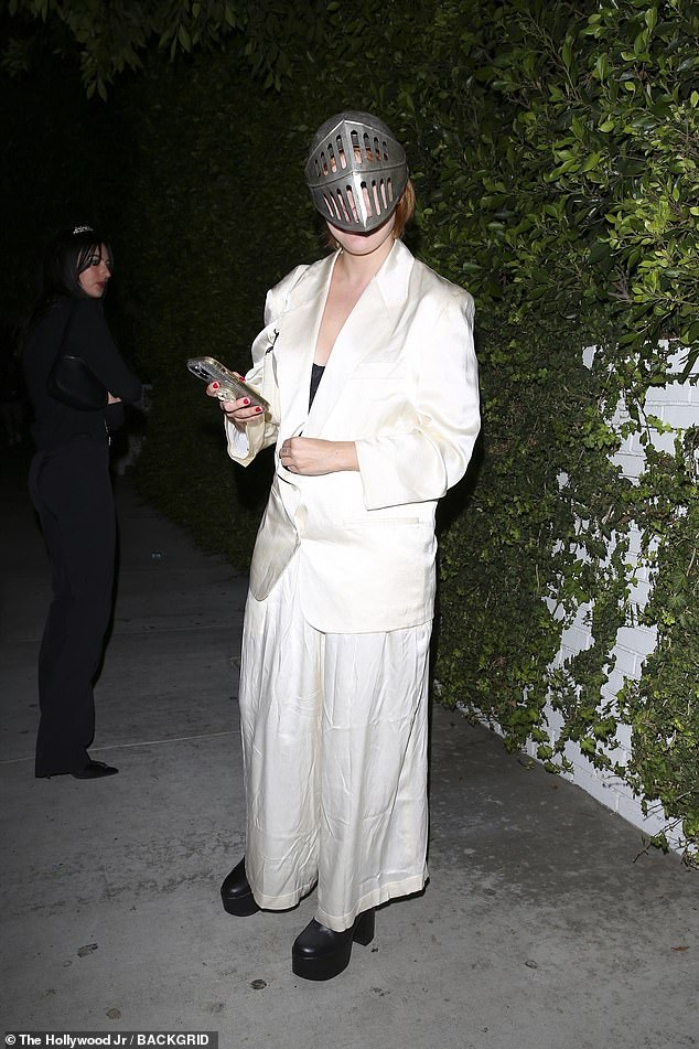 Tallulah Willis was dressed to impress in an oversized white trouser suit and sinister silver mask