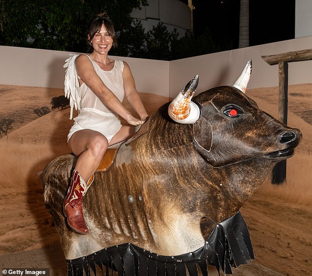 Despite the challenge she flashed a huge smile as he struggled to stay on the bull