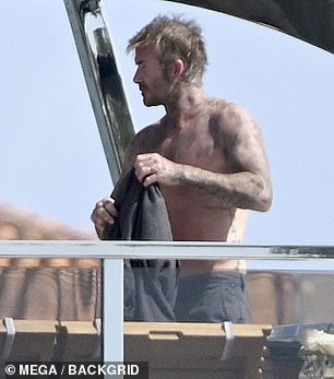 After a little too much tanning David pulled on a dark grey T-shirt