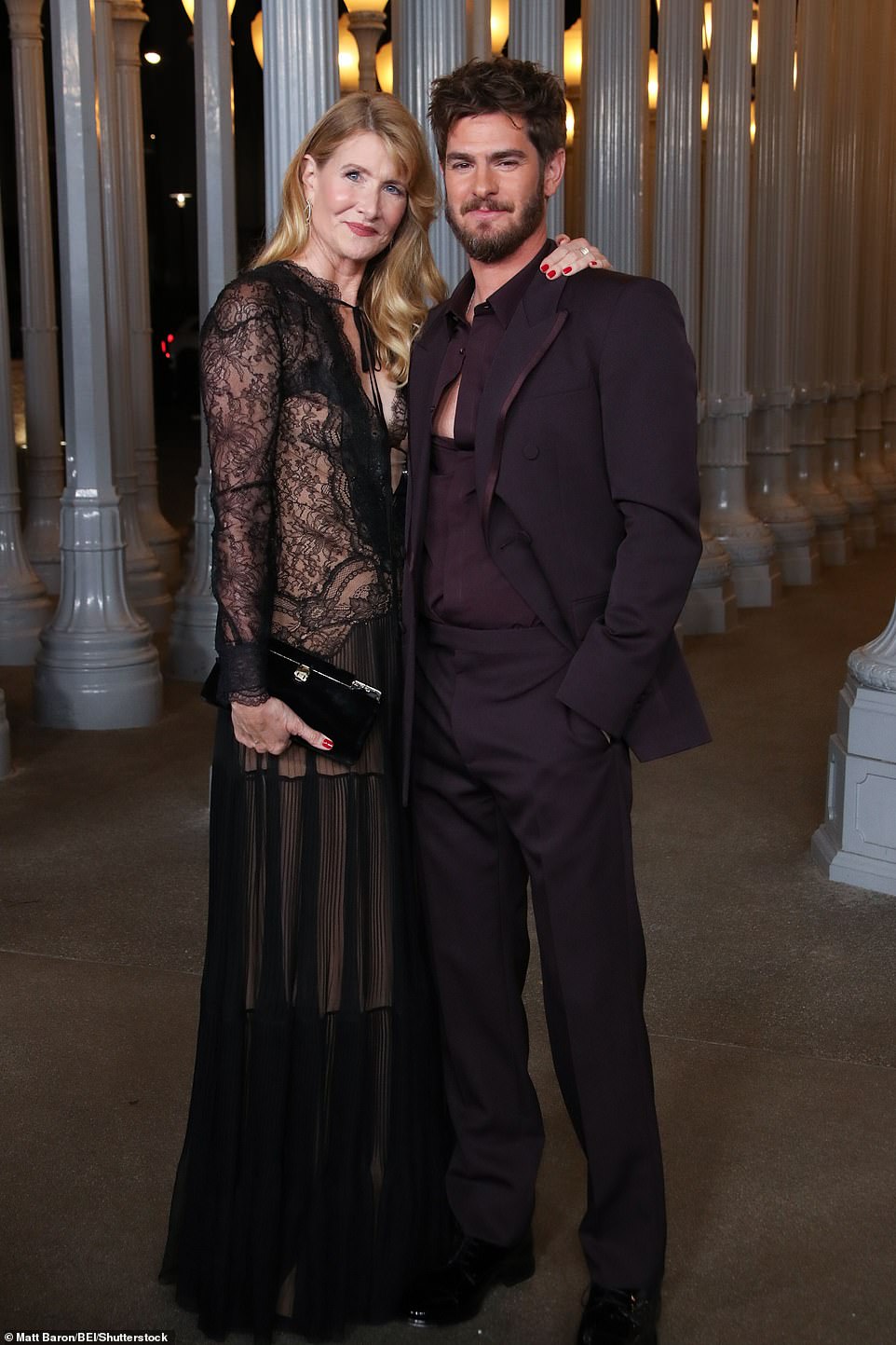 Andrew Garfield, who put on a dapper display in an aubergine-colored suit with his shirt halfway unbuttoned, was seen at the gala with Laura Dern