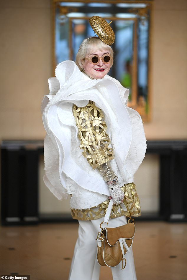 Deborah Quinn put on a very quirky display in a white layered shirt with unique gold sleeves as she made quite the entrance to the event