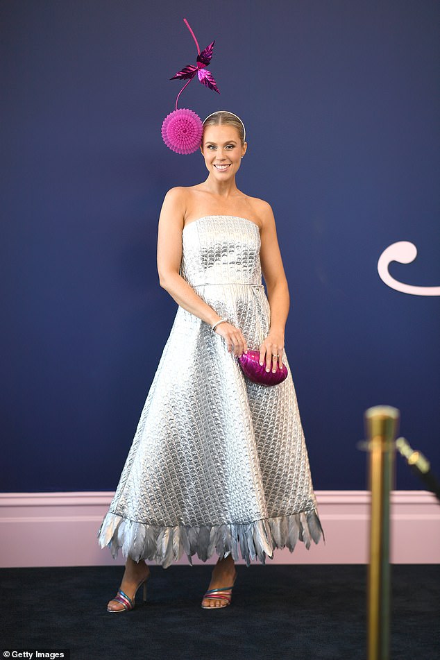 Crystal Kimber-Peters made sure to capture attention in a shimmering metallic silver strapless dress, which she styled with rainbow strapped heels