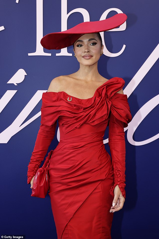 The 2017 Miss Universe Australia winner, 32, fixed a huge wide-brimmed hat on top of her glossy brunette locks as she kept in line with the racing day dress code