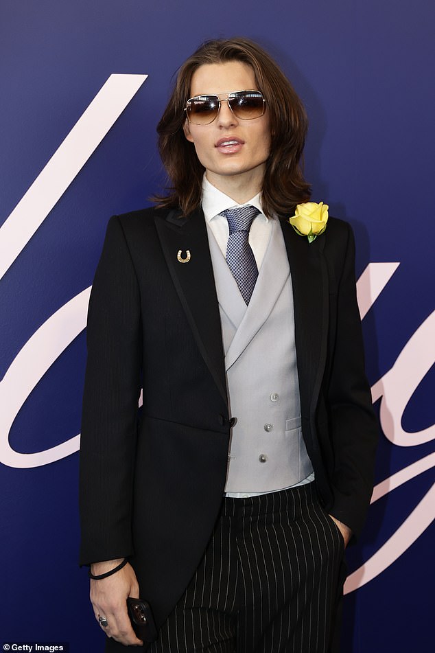 He also coordinated with his beloved mother as he fixed a yellow flower into his lapel to complete his suave ensemble